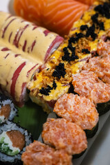Freshly prepared sushi platter featuring various rolls with seafood and toppings ready to enjoy