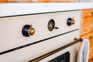 Vintage stove with intricate knobs in a cozy kitchen setting during daylight hours