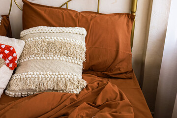 Decorated bed with cozy pillows and warm blankets in a tranquil bedroom setting
