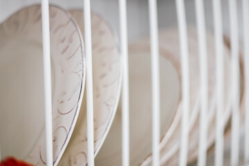 Colorful plates drying in a dish rack after washing