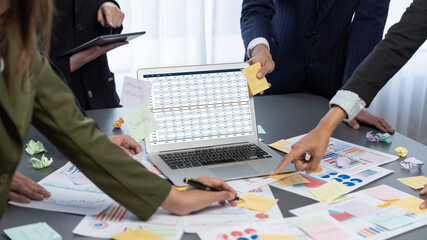Analyst team use sticky note for creative and analytic brainstorm for business idea with BI data dashboard on laptop screen. Analysis financial data visualization tech for marketing strategy. Prodigy