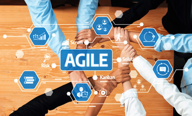 This image captures a diverse group united in a collaborative effort using digital tools,...