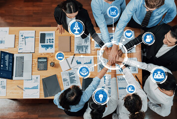 Aerial view of diverse team members engaged in a collaborative business meeting, showcasing active...