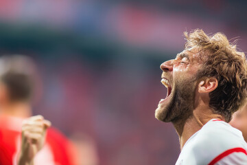Soccer player celebrating with joy and excitement, showcasing intense emotion and passion for game