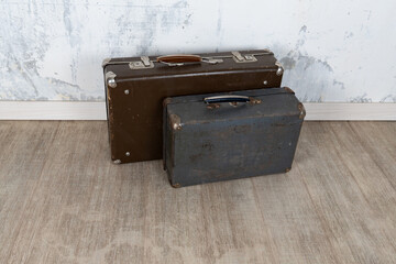Vintage old classic travel leather suitcases circa 1940-60s. Travel luggage concept. Retro suitcases on a white wall background.