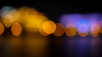 A blurred bokeh shot of colorful lights at night, creating an abstract, vibrant effect.