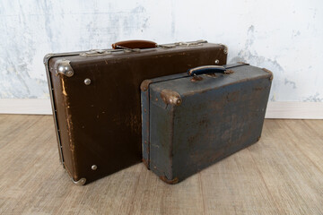 Vintage old classic travel leather suitcases circa 1940-60s. Travel luggage concept. Retro suitcases on a white wall background.