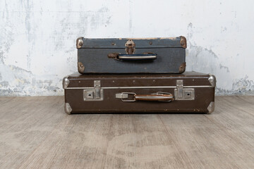Vintage old classic travel leather suitcases circa 1940-60s. Travel luggage concept. Retro suitcases on a white wall background.