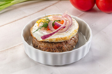 Beefsteak chop with roasted egg