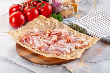 Sliced pork bacon over board