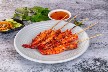 Grilled prawn skewer served sauce