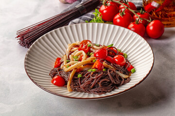 Black rice pasta with squid and tomato
