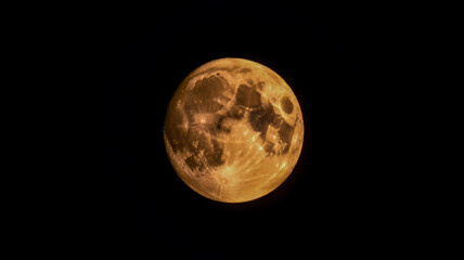 Fototapeta premium A close-up photograph of a half-moon against a pure black background.