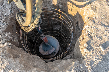 Construction equipment drilling vertical hole for a cast in place reinforced concrete pile...