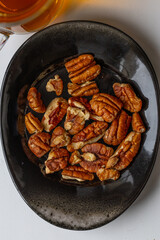 Peeled pecans on a saucer top view