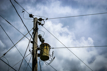 a pole-mounted distribution transformer, a common sight in electrical power distribution systems....