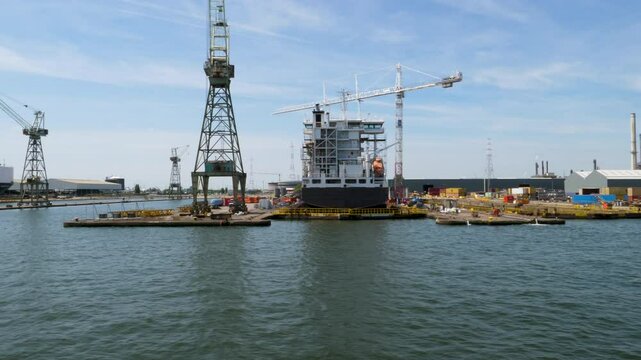Antwerp, Belgium - June 20, 2025: Shipyard and large industrial ships  on River Scheldt in the port of Antwerp