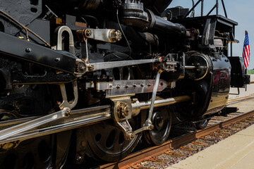 Side of Vintage Steam Locomotive With American Flag
