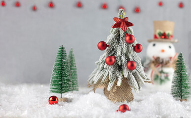 Christmas card. Christmas tree with red balls. Snowman. Christmas and festive atmosphere