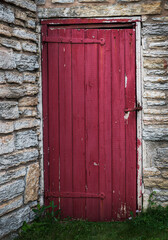 Closed Red Door in Limestone Wall