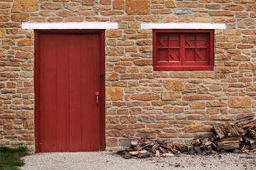 Red Door and Shuttered Window in Limestone Wall