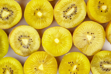 Yellow gold kiwi fruit halves arranged in a vibrant display, showcasing their juicy texture and...