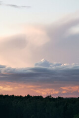 Expansive sky at sunset, showcasing vibrant hues of orange and pink, with fluffy clouds above a...