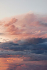 Soft pastel clouds in a serene sky during sunset, showcasing a beautiful blend of colors and...