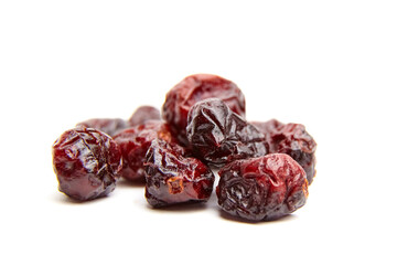 Dried cranberries arranged artistically on a white background, showcasing their rich color and...
