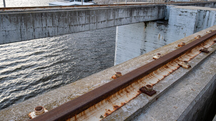 Rusty rail on concrete hydro structure