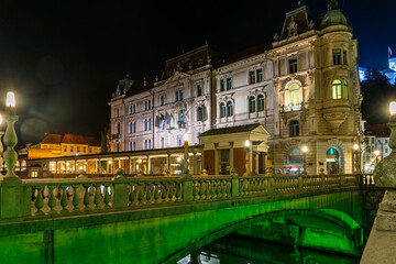 Ljubljanica riverfront at night with reflections and glowing lights