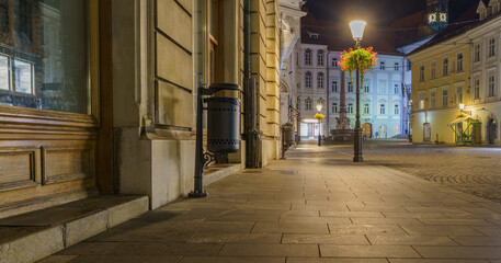 Quiet streets of Ljubljana Old Town at night with lamps and flowers