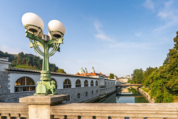 Ljubljanica river with historic bridges and market hall in Ljubljana