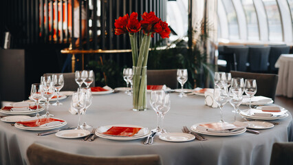 Elegant Table Setting with Red Flowers