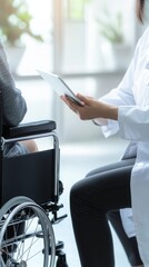 Medical professional reviewing digital information with wheelchair-bound patient, demonstrating collaborative healthcare technology and personalized patient support