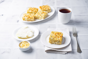 Cabbage cheese casserole in a plate on a white background