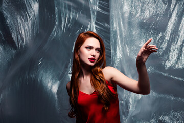 Rich attractive young Woman Posing with Stylish Red Hair in Front of a Modern Artistic Background
