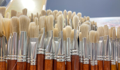 Assorted paintbrushes arranged in a holder.