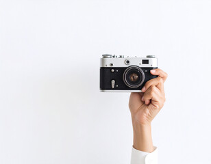 Hand Holding Vintage Camera Against White Background