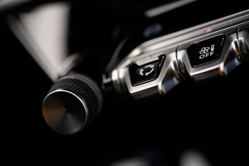  Close-up photo of the climate control button on the dashboard of a modern car