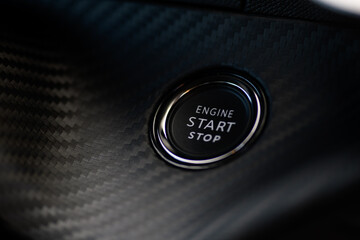 Close-up photo of the start stop button on the dashboard of a modern car