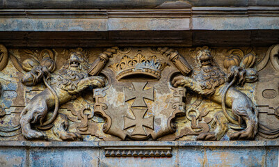 Medieval stone panel with lions and royal coat of arms. Bas relief 