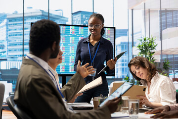 Executive board members meeting in conference room to establish future growth plan, ensuring...