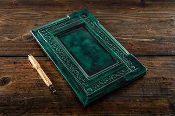 An old book in a room with other leather books