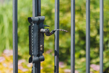 Close-up of Vintage Iron Gate Handle in Sunny Garden