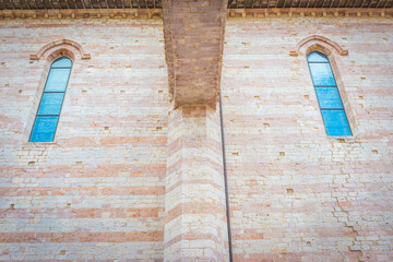 historic architecture with symmetrical windows, a close-up view of a historic brick wall with two...
