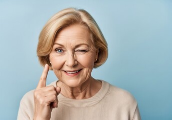 Expressive Senior Lady Winking. A cheerful older woman with a knowing eye gesture and an upward pointed finger conveys a playful secret, an insight, or a moment of fun.