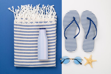 Beach towel with summer accessories on color background, top view