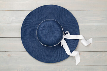 Blue beach hat on wooden background,top view