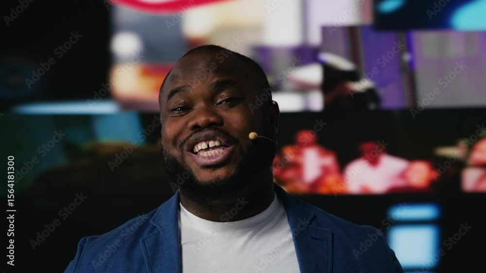 Poster black web coach hosting a discussion on stage surrounded by media visuals, symbolizing global networ